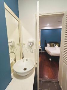 a bathroom with a sink and a bedroom with a bed at Luang Prabang Nagara Villa River View in Luang Prabang
