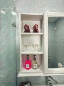 a bathroom with a shelf with bottles and a shower at Luang Prabang Nagara Villa River View in Luang Prabang +54 photos