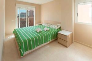 a bedroom with two stuffed animals sitting on a bed at Mar de Coral in El Verger