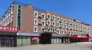 a large brick building on a city street at GreenTree Inn Beijing Daxing District Yufa Town New Airport Express Hotel in Beijing