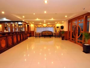 a lobby with a table and chairs in a building at Jun Yue Hotel in Phnom Penh