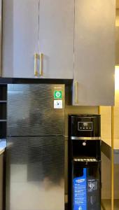 a kitchen with a stainless steel refrigerator and a stove at Kryvon Studio Apartment in Leuweungmalang +4 photos