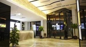 a lobby with potted plants in a building at Lavande Hotel Xian Gaoxin Branch in Xi'an