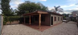 a small building with a roof on top of it at Casa El Aromito Anisacate in Villa Anizacate