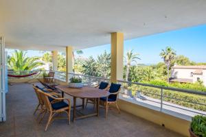 a patio with a table and chairs on a balcony at Villa Berry in Santa Ponsa