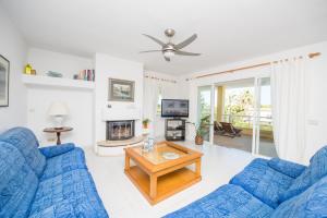 a living room with two blue couches and a table at Villa Berry in Santa Ponsa