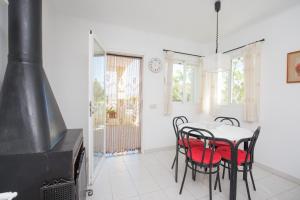 a dining room with a table and chairs and a stove at Villa Berry in Santa Ponsa