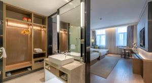 a bathroom with a sink and a large mirror at Echarm Hotel Jinan Railway Station Daming Lake in Jinan +222 photos