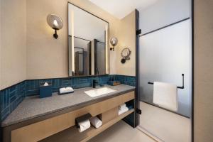 a bathroom with a sink and a mirror at Four Points by Sheraton Tianjin Jiefang Bridge in Tianjin +15 photos