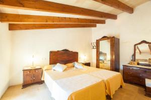 a bedroom with a large bed and a mirror at Son Gorrió in Sant Llorenç des Cardassar +17 photos