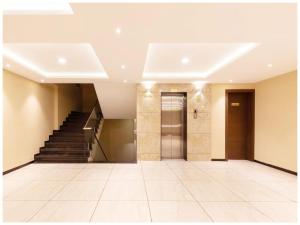an empty lobby with stairs and a hallway at Hotel Shriniwash Residency Near Shri Mahakaleshwar Jyotirlinga Temple in Ujjain +13 photos