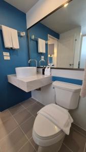 a bathroom with a toilet and a sink and a mirror at Days Inn by Wyndham Patong Beach in Patong Beach
