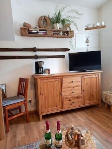 Sehma2-Personen-Apartment的客厅里有一台电视和两瓶啤酒