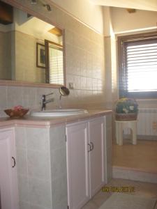 a bathroom with a sink and a mirror at Appartamento Camera Da Stefy in Bastia Umbra