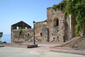 an old stone building with a street light in front of it at Apartamentos Balcón de Maro in Maro