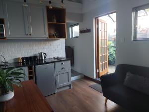 a kitchen with a counter and a table in a room at Fevertree cottage in Bloemfontein
