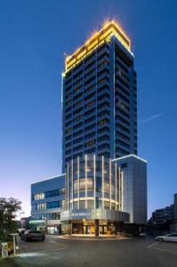 a tall building with lights on top of it at Kunming Guihua Hotel in Kunming