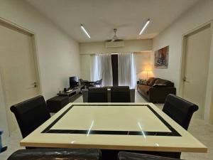 a large living room with a table and chairs at By The Sea@ Cozy Beachfront Home (Batu Ferringhi). in Batu Ferringhi +289 photos