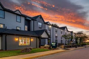 a row of houses on a street at sunset at MainStay Suites Sterling near Dulles Town Center in Sterling
