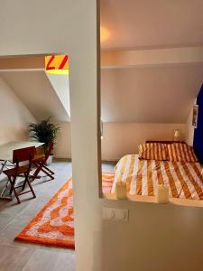 a bedroom with a bed and a table in a room at Charming Studio In Le Mans Chasse Royale in Le Mans