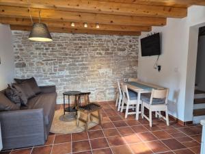 a living room with a couch and a table at Akvamarin Stone House in Medulin