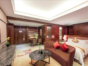 a hotel room with a bed and a couch and a table at Cinese Hotel Dongguan in Dongguan +234 photos