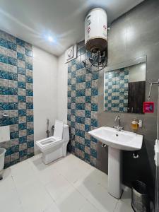 a bathroom with a sink and a toilet in it at The Edge Retreat A Premium Property in Mussoorie