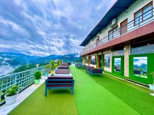 a row of benches on the balcony of a building at The Edge Retreat A Premium Property in Mussoorie