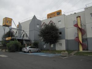 a car parked in a parking lot in front of a building at hotelF1 Paris Villemomble in Villemomble