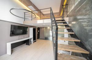 a staircase in a house with a flat screen tv at 구로 서울 인 호텔 in Seoul