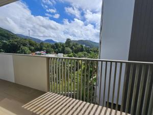 a balcony with a view of the mountains at By The Sea Cozy Beachfront Home 253 in Batu Ferringhi