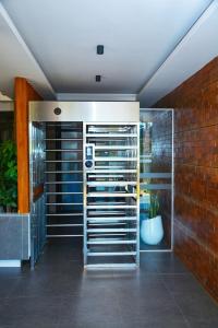 a room with a brick wall and a metal rack at Tsavo Stanley kiambu Road in Gatunga