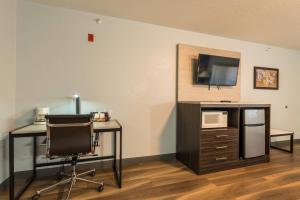 a room with a desk and a chair and a tv at Quality Inn & Suites Manitou Springs at Pikes Peak in Manitou Springs