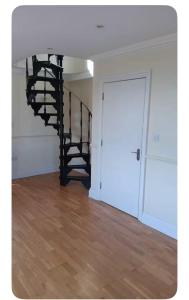 a room with a spiral staircase in a house at Graceful Getaway Free Parking in Windsor +3 photos