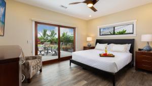 a bedroom with a bed and a living room with a patio at ISLAND SEABATICAL Restful 3BR Ainamalu Home with Private Pool in Waikoloa +75 photos