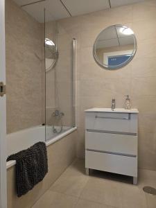 a bathroom with a shower and a sink and a mirror at New appartment with seaview in Almerimar