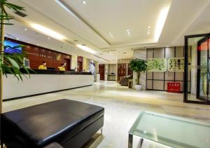 a lobby with a bench and a bar in a building at City Comfort Inn Hotel Guiyang Normal University Yangmingci Metro Station in Guiyang