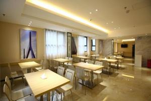 a restaurant with tables and chairs in a room at City Comfort Inn Hotel Guiyang Normal University Yangmingci Metro Station in Guiyang