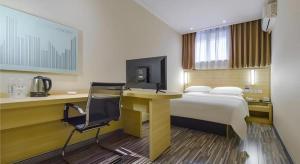 a hotel room with a bed and a desk with a computer at City Comfort Inn Hotel Guiyang Normal University Yangmingci Metro Station in Guiyang +239 photos