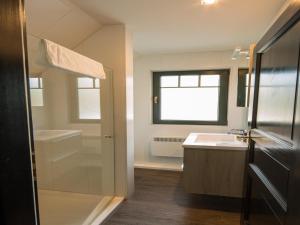 a bathroom with a sink and a tub and a shower at Doppelhaushälften im Naturresort Drewitz in Drewitz +21 photos