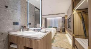 a bathroom with a sink and a large mirror at Aden Select Shenzhen Taizi in Shenzhen +101 photos
