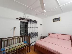 a bedroom with a pink bed and a window at Bee Cottage Negombo in Negombo +37 photos
