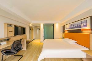 a hotel room with a bed and a chair at 7Days Premium Chongqing Jiangbei International Airport Rongchuang in Chongqing