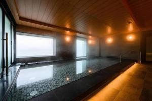 a large swimming pool in a room with a window at KEIKYU EX INN Haneda Innovation City 2 minutes walk from HICity Exit of Tenkubashi Station in Tokyo