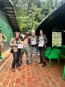 a group of people are holding up certificates at Brian's wild safaris in Fort Portal