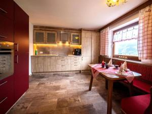 a kitchen with a wooden table and a window at Chalet in Fügen near Spieljoch Ski Lift in Fügen