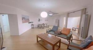 a living room with a couch and a table at Qingdao Donghai Hotel in Qingdao +134 photos