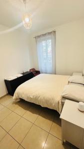 a bedroom with two beds and a chandelier at Chambre d hotes Marseille Prado in Marseille