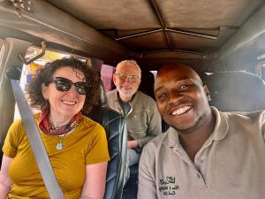 a group of people sitting on a bus at Brian's wild safaris in Fort Portal