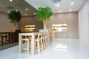 a restaurant with a table and chairs and trees at Timber Hotel in Ban Bang Rathuk